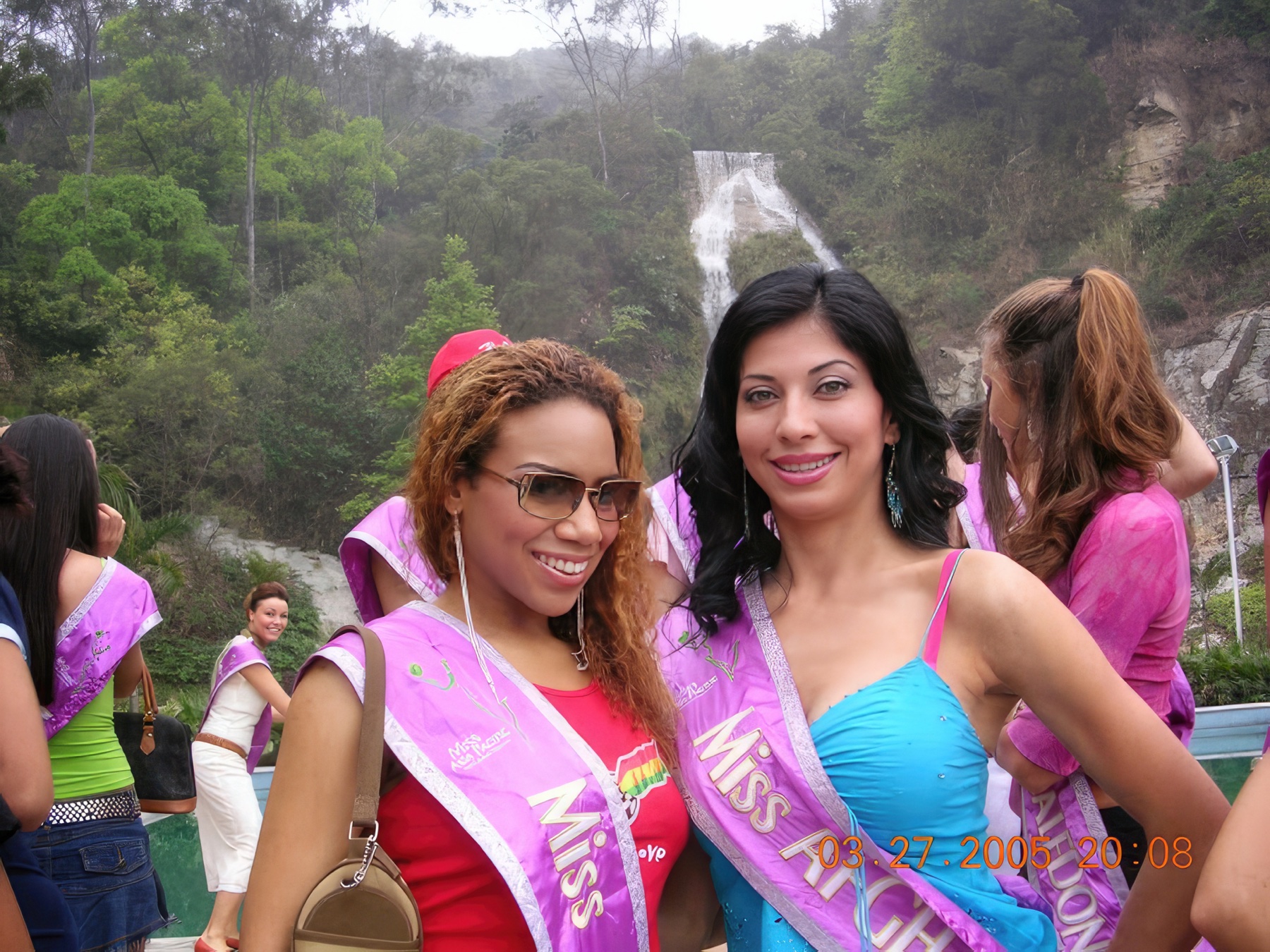 Daisi and a fellow delegate beside a waterfall during an excursion in China.