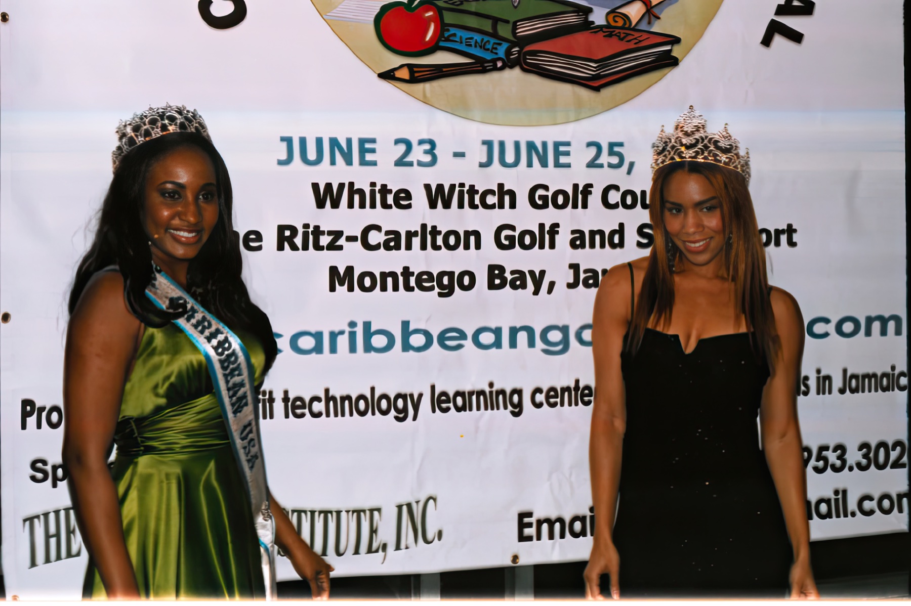 Daisi and another crowned participant beside a Montego Bay golf event banner supporting technology learning centers in Jamaica.