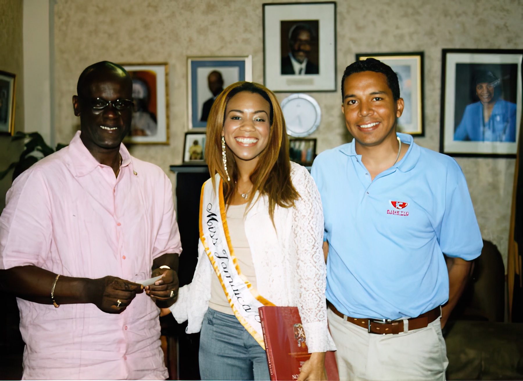 Daisi with Desmond McKenzie, then Mayor of Kingston, and another participant during an office visit.